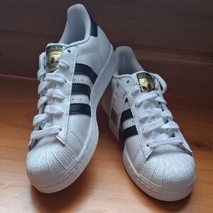Adidas White Sneakers with Black Stripes and Gold Logo